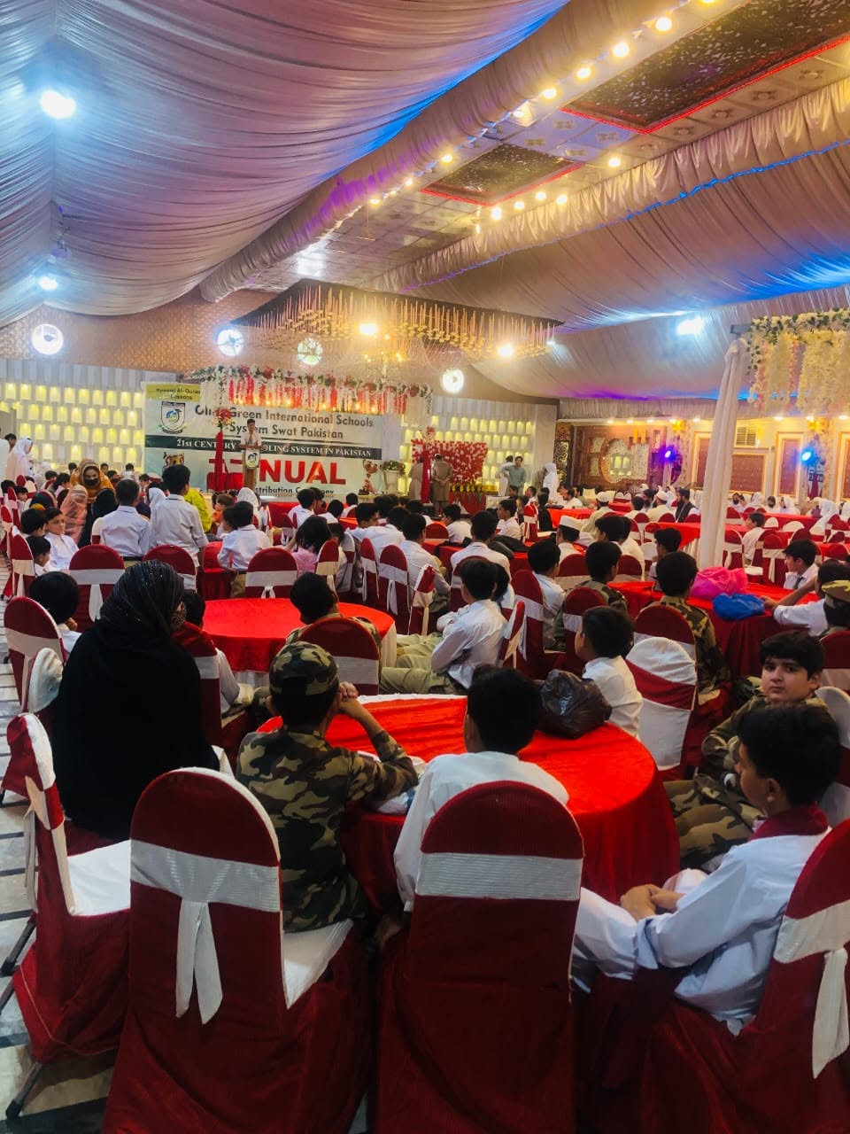 Olive Green annual function with students and guests in the hall