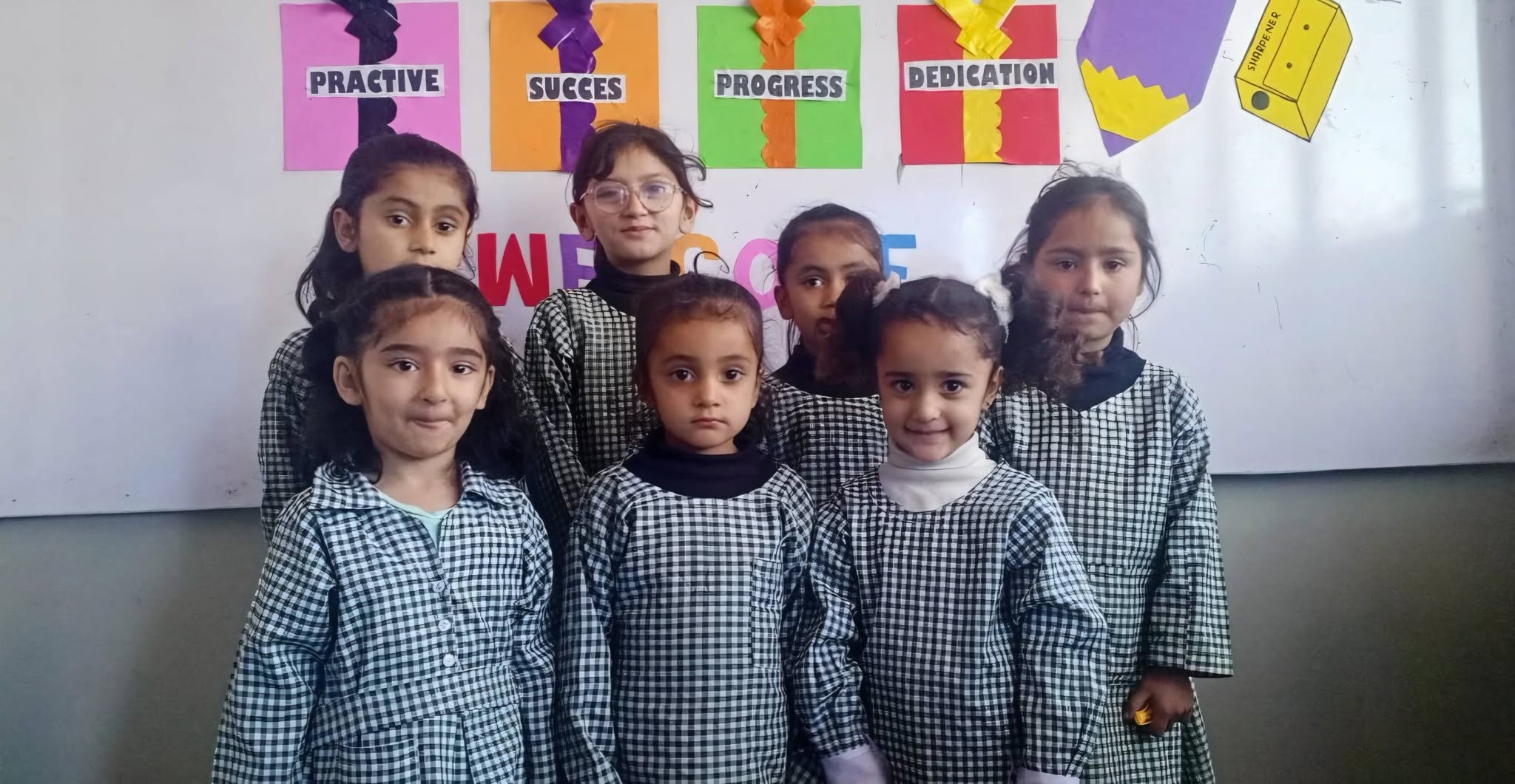 Young students in front of the welcome display