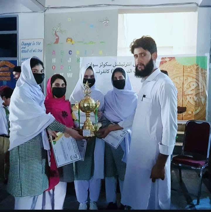 Students holding a winning trophy